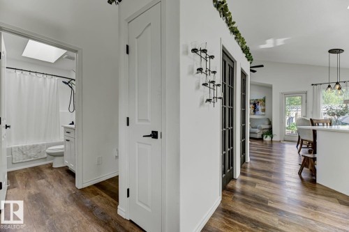 Modern bathroom featuring a skylight, white subway tile shower, and a single vanity with dark hardware - 3208 135A Avenue, Edmonton, AB - Indoor Photo Showing Other Room