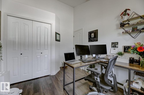 Versatile room featuring wood-finish flooring, white walls, and a built-in bi-fold closet - 3208 135A Avenue, Edmonton, AB - Indoor Photo Showing Office