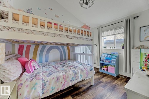 Room featuring wood-finish flooring and a white bunk bed - 3208 135A Avenue, Edmonton, AB - Indoor Photo Showing Bedroom