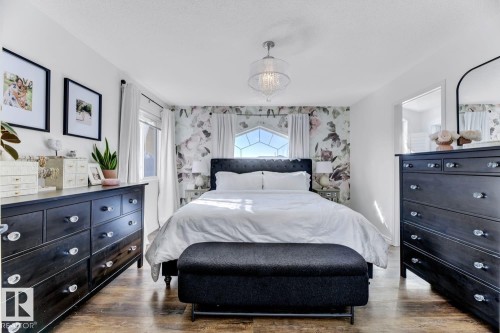 Bedroom featuring wood-finish flooring and a central lighting fixture - 3208 135A Avenue, Edmonton, AB - Indoor Photo Showing Bedroom