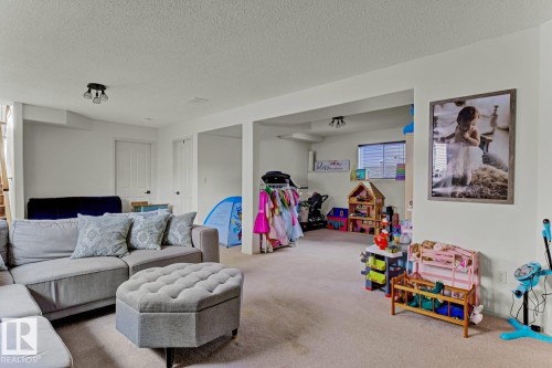 Open-concept living space featuring neutral carpeting, white walls, and recessed lighting - 3208 135A Avenue, Edmonton, AB - Indoor