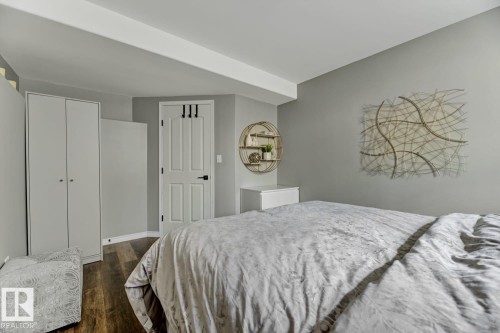 Interior room featuring wood-finish flooring, light gray walls, and white trim - 3208 135A Avenue, Edmonton, AB - Indoor Photo Showing Bedroom