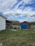 Outbuilding with wood siding and a covered storage area - 53559 Range Rd 220, Rural Strathcona County, AB  - Outdoor 