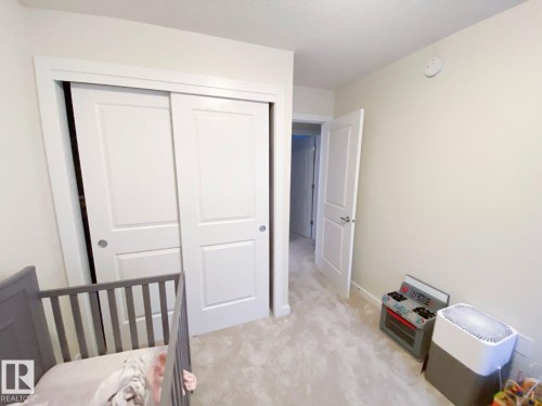 Neutral-toned carpeting complements the light wall color and white trim - 118 655 Watt Boulevard, Edmonton, AB - Indoor