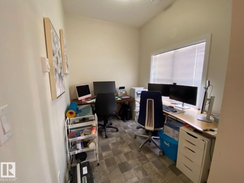 Dedicated workspace featuring neutral wall tones and patterned tile flooring - 118 655 Watt Boulevard, Edmonton, AB - Indoor Photo Showing Office