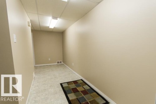 The property features light-colored walls, tile flooring, and ceiling lights - 10806 64 Avenue, Edmonton, AB - Indoor