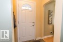 Entryway featuring a paneled door with an arched window, light-colored walls, and a tiled floor - 10806 64 Avenue, Edmonton, AB  - Indoor Photo Showing Other Room 