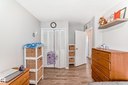 Room featuring wood-finish flooring, light gray wall paint, and white trim - 1804 51 Street Nw, Edmonton, AB - Indoor