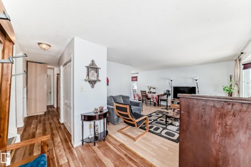 Hallway entry with wood-finish flooring, recessed lighting, and white panel doors - 1804 51 Street Nw, Edmonton, AB - Indoor