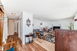 Hallway entry with wood-finish flooring, recessed lighting, and white panel doors - 