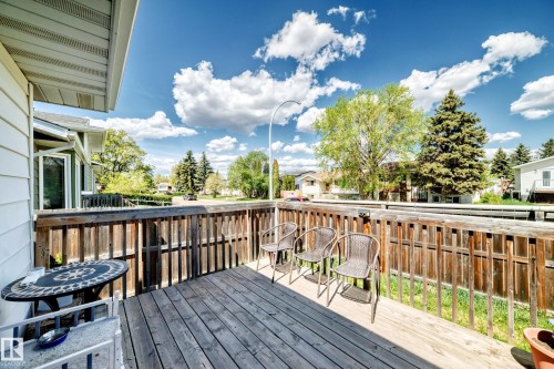 Spacious wood deck featuring a slatted wood railing, wood-finish flooring, and ample outdoor living area - 1804 51 Street Nw, Edmonton, AB - Outdoor With Exterior