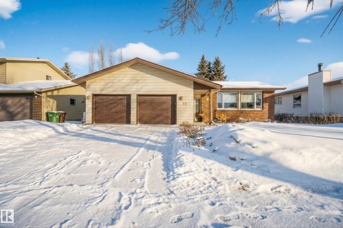 The property features a two-car garage with brown doors and a light-colored siding facade - 17 Austin Crescent, St. Albert, AB - Outdoor