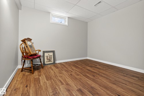 This room features hardwood-style flooring, light gray walls, and white trim - 17 Austin Crescent, St. Albert, AB - Indoor Photo Showing Other Room