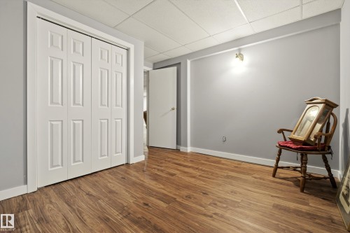 This room features wood-look flooring and light grey walls - 17 Austin Crescent, St. Albert, AB - Indoor Photo Showing Other Room