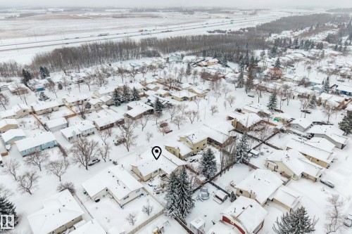 Aerial view of the property and surrounding neighborhood, featuring numerous residential homes with snow-covered roofs and yards - 17 Austin Crescent, St. Albert, AB - Outdoor With View