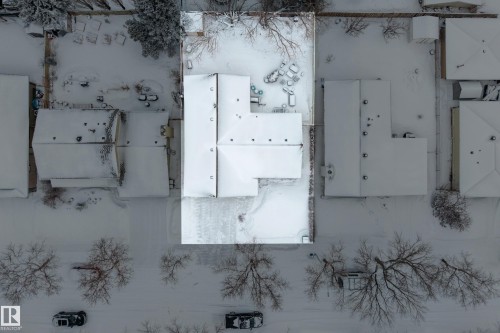 The property features a private yard and a single-story structure with a snow-covered roof - 17 Austin Crescent, St. Albert, AB - 