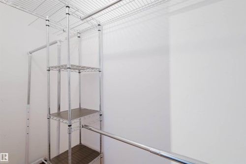 White-walled closet featuring a wire shelving system and chrome hanging rods - 10511 80 Street, Edmonton, AB - Indoor