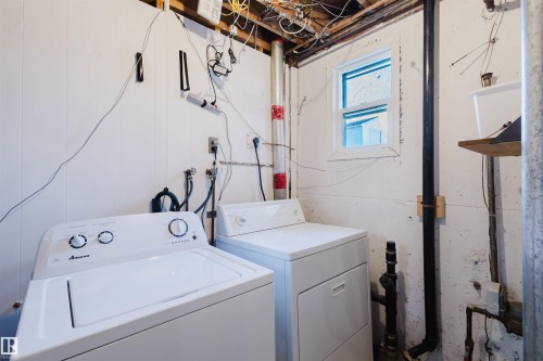 Dedicated laundry area featuring white paneled walls and a built-in window - 10511 80 Street, Edmonton, AB - Indoor Photo Showing Laundry Room