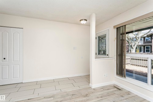 Interior space featuring light-toned walls, wood-finish flooring, and white baseboards - 9221 172 Street, Edmonton, AB - Indoor Photo Showing Other Room