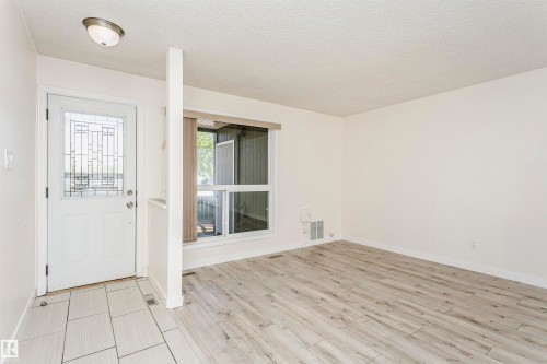 Entryway featuring a decorative glass paneled door, light-toned rectangular tile flooring, and a flush mount ceiling light - 9221 172 Street, Edmonton, AB - Indoor Photo Showing Other Room