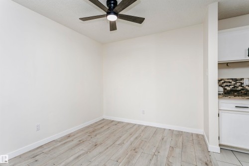 Light wood-finish flooring with white baseboards and neutral wall tones - 9221 172 Street, Edmonton, AB - Indoor Photo Showing Other Room