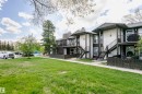 Multi-unit residential property featuring stucco siding and dark trim accents - 9221 172 Street, Edmonton, AB  - Outdoor 