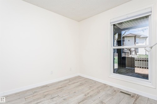 Bright interior space featuring light-toned walls and wood-finish flooring - 9221 172 Street, Edmonton, AB - Indoor Photo Showing Other Room
