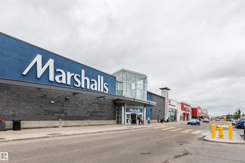 Retail storefront featuring prominent signage, a glass-enclosed entrance, and dark masonry accents - 9221 172 Street, Edmonton, AB - Outdoor