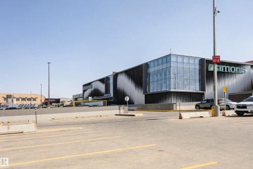 Commercial building exterior featuring a prominent glass facade, corrugated metal siding, and a large branded sign - 9221 172 Street, Edmonton, AB - Outdoor
