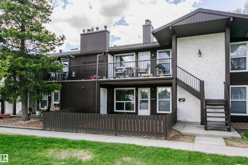 Multi-level townhouse exterior featuring dark brown siding and white stucco accents - 9221 172 Street, Edmonton, AB - Outdoor