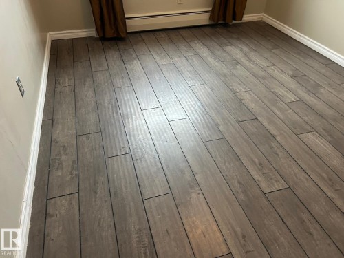 LAMINATE FLOORING THROUGHOUT THE UNUT - 4 10164 150 Street, Edmonton, AB - Indoor Photo Showing Other Room