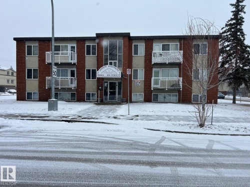 The property is a three-story building featuring a brick exterior and individual balconies - 4 10164 150 Street, Edmonton, AB - Outdoor With Facade