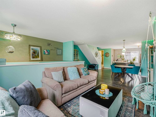 Open concept living space with dark wood-finish flooring - 44 1140 Chappelle Boulevard, Edmonton, AB - Indoor Photo Showing Living Room