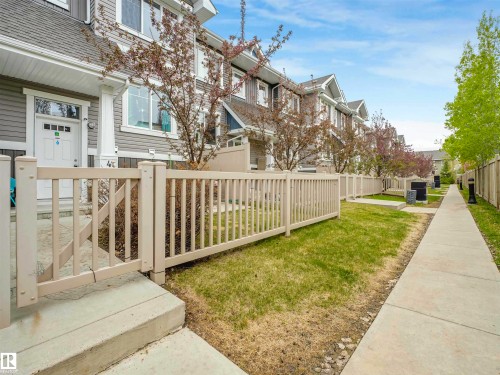 Townhouse exterior featuring gray siding and white trim - 44 1140 Chappelle Boulevard, Edmonton, AB - Outdoor