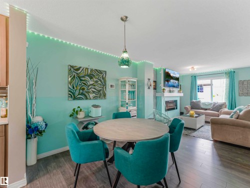 Open concept living space featuring a dining area with pendant lighting - 44 1140 Chappelle Boulevard, Edmonton, AB - Indoor With Fireplace