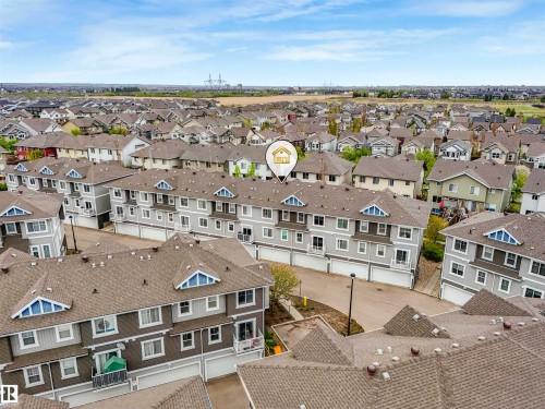 Aerial perspective showcasing a residential community with a mix of detached homes and multi-story townhomes - 44 1140 Chappelle Boulevard, Edmonton, AB - Outdoor