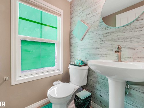 White pedestal sink with a contemporary brushed nickel faucet - 44 1140 Chappelle Boulevard, Edmonton, AB - Indoor Photo Showing Bathroom