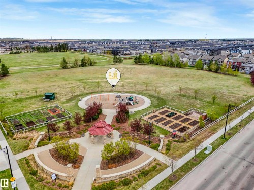 Community park featuring a red-roofed gazebo, a children's play area, and raised garden beds - 44 1140 Chappelle Boulevard, Edmonton, AB - Outdoor With View