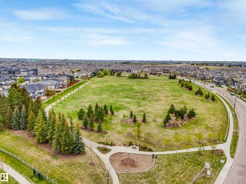 Expansive green space featuring mature trees, paved walking paths, and residential surroundings - 44 1140 Chappelle Boulevard, Edmonton, AB - Outdoor With View