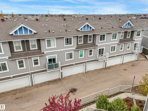Multi-level residential building featuring light grey siding and white trim - 44 1140 Chappelle Boulevard, Edmonton, AB - Outdoor
