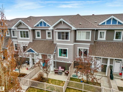 Three-story townhome with a light gray and dark gray siding exterior - 44 1140 Chappelle Boulevard, Edmonton, AB - Outdoor With Facade