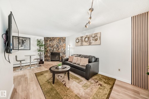 G3 10138 116 Street, Edmonton, AB - Indoor Photo Showing Living Room With Fireplace