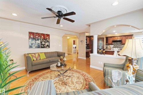Open-concept living area featuring light wood-finish flooring, recessed lighting, and a decorative ceiling fan - 6116 53 Avenue, Beaumont, AB - Indoor Photo Showing Living Room