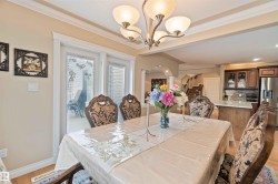 Dining area featuring wood-finish flooring, crown molding, and a five-light chandelier - 