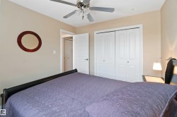 Neutral-toned room featuring a ceiling fan with light fixture, white bi-fold closet doors, and recessed lighting - 