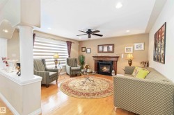 Living space featuring wood-finish flooring, recessed lighting, and a ceiling fan - 