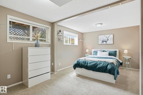 Bedroom featuring carpeting, light beige wall paint, two windows with blinds, and recessed lighting - 14017 156 Avenue, Edmonton, AB - Indoor Photo Showing Bedroom
