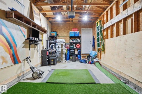 Concrete floor garage with exposed wood ceiling beams and wall studs - 14017 156 Avenue, Edmonton, AB - Indoor