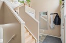 Two-story entry foyer featuring a light wood-finish staircase with white trim, neutral wall tones, and a ceiling fan - 14017 156 Avenue, Edmonton, AB  - Indoor Photo Showing Other Room 