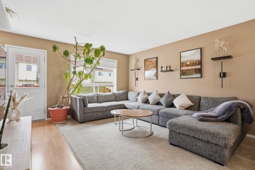 Living area featuring light-toned walls and wood-finish flooring - 14017 156 Avenue, Edmonton, AB - Indoor Photo Showing Living Room